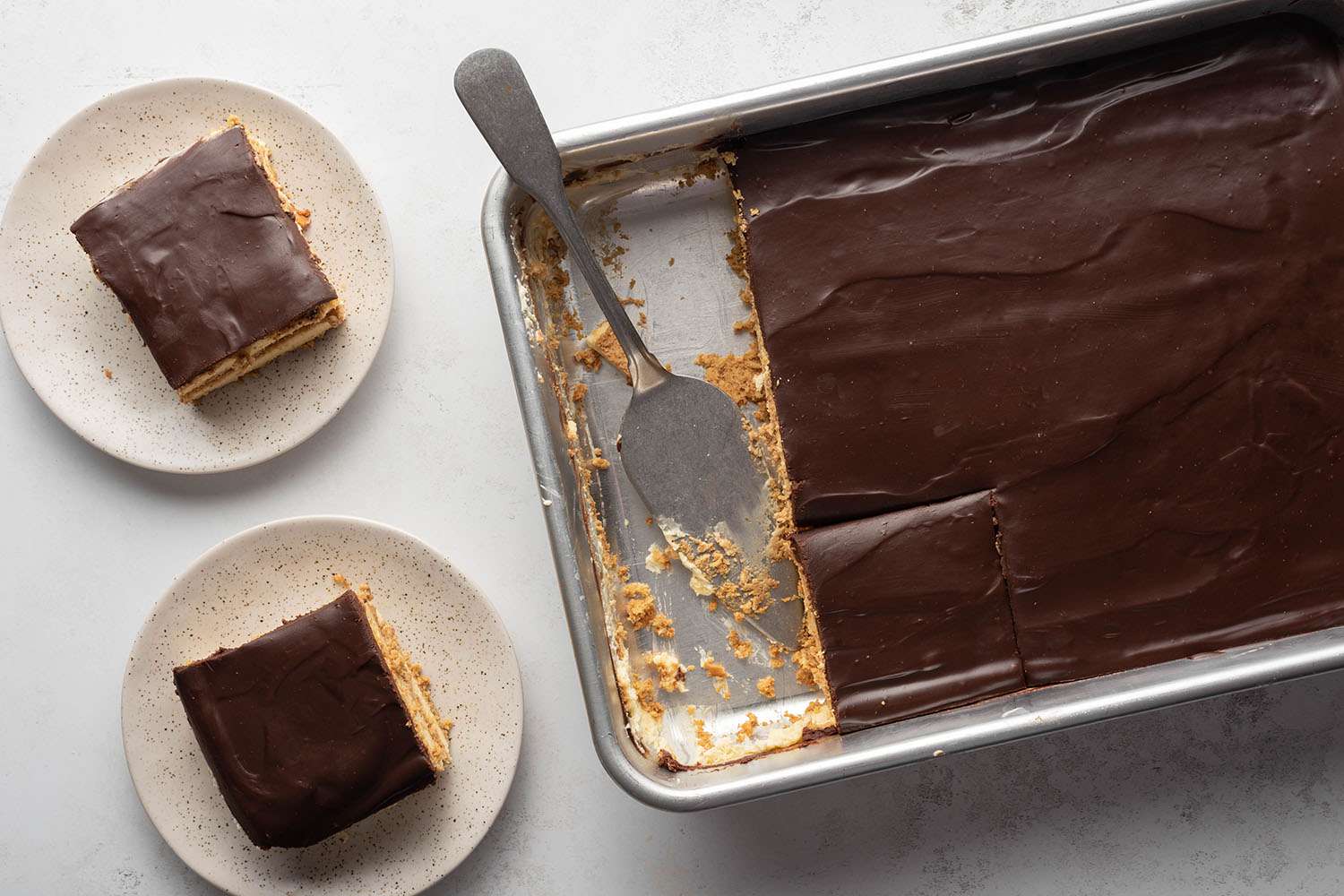 Chocolate Eclair Cake in a baking dish and on plates 