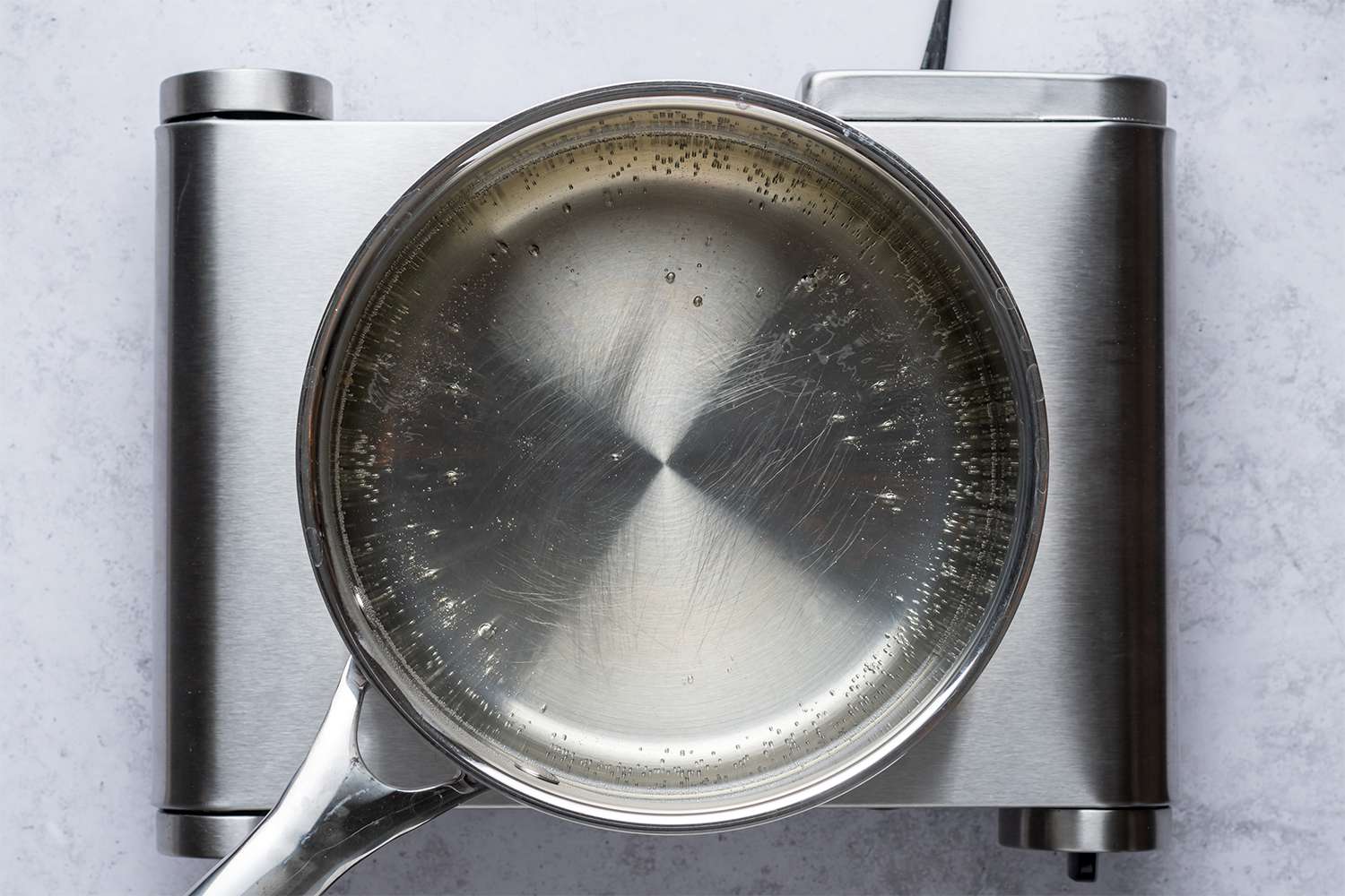 Water, sugar and salt mixture in a saucepan on a burner 