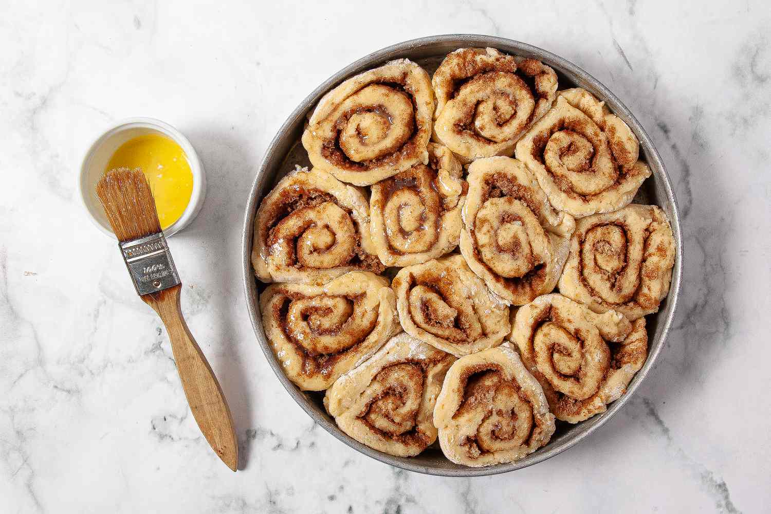 brush tops of cinnamon rolls with butter