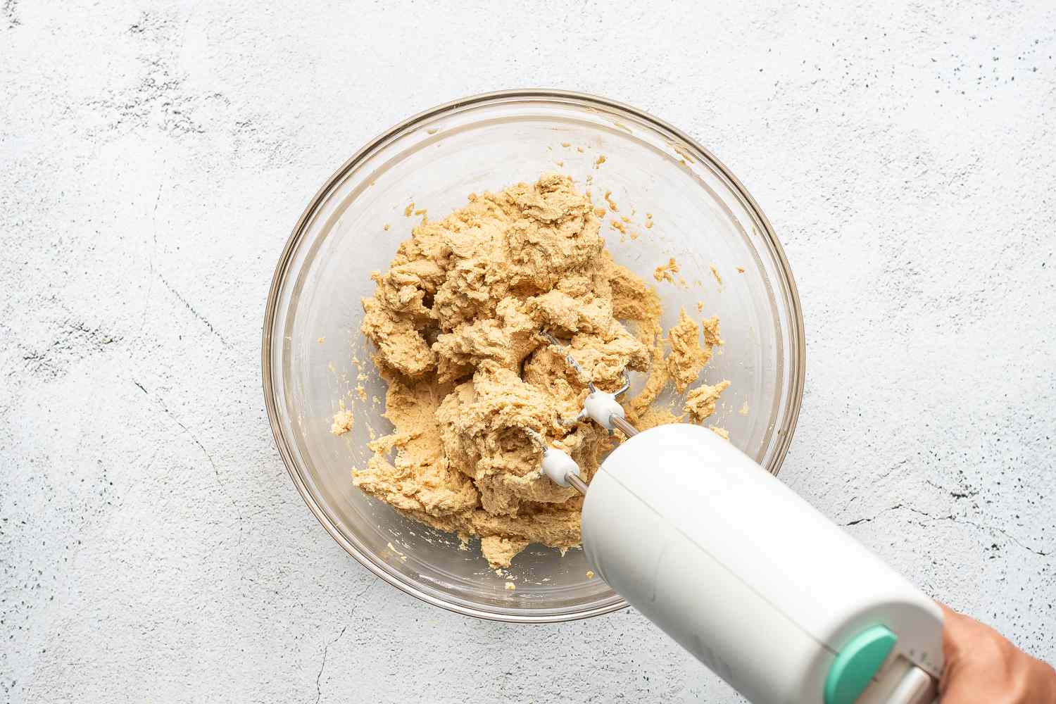 cookie dough in a bowl, hand mixer 