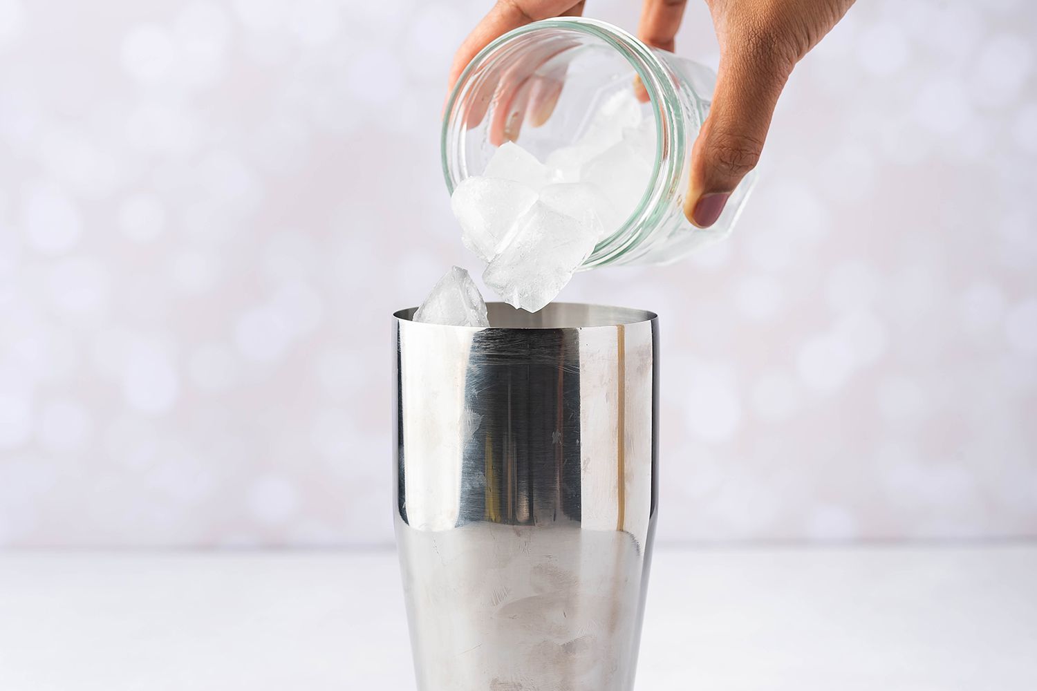 pouring ice in cocktail shaker