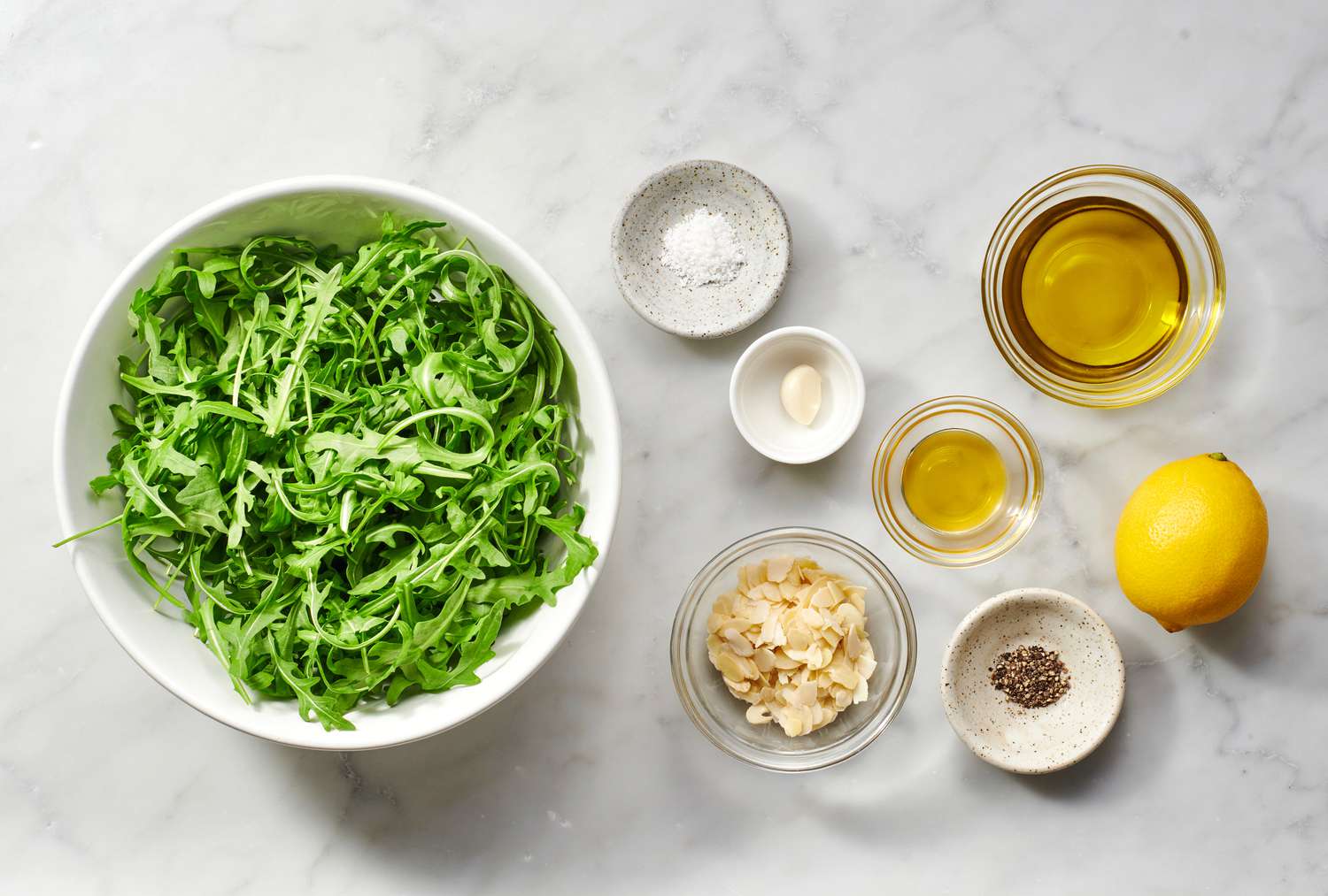ingredients gathered for arugula salad with whole lemon dressing