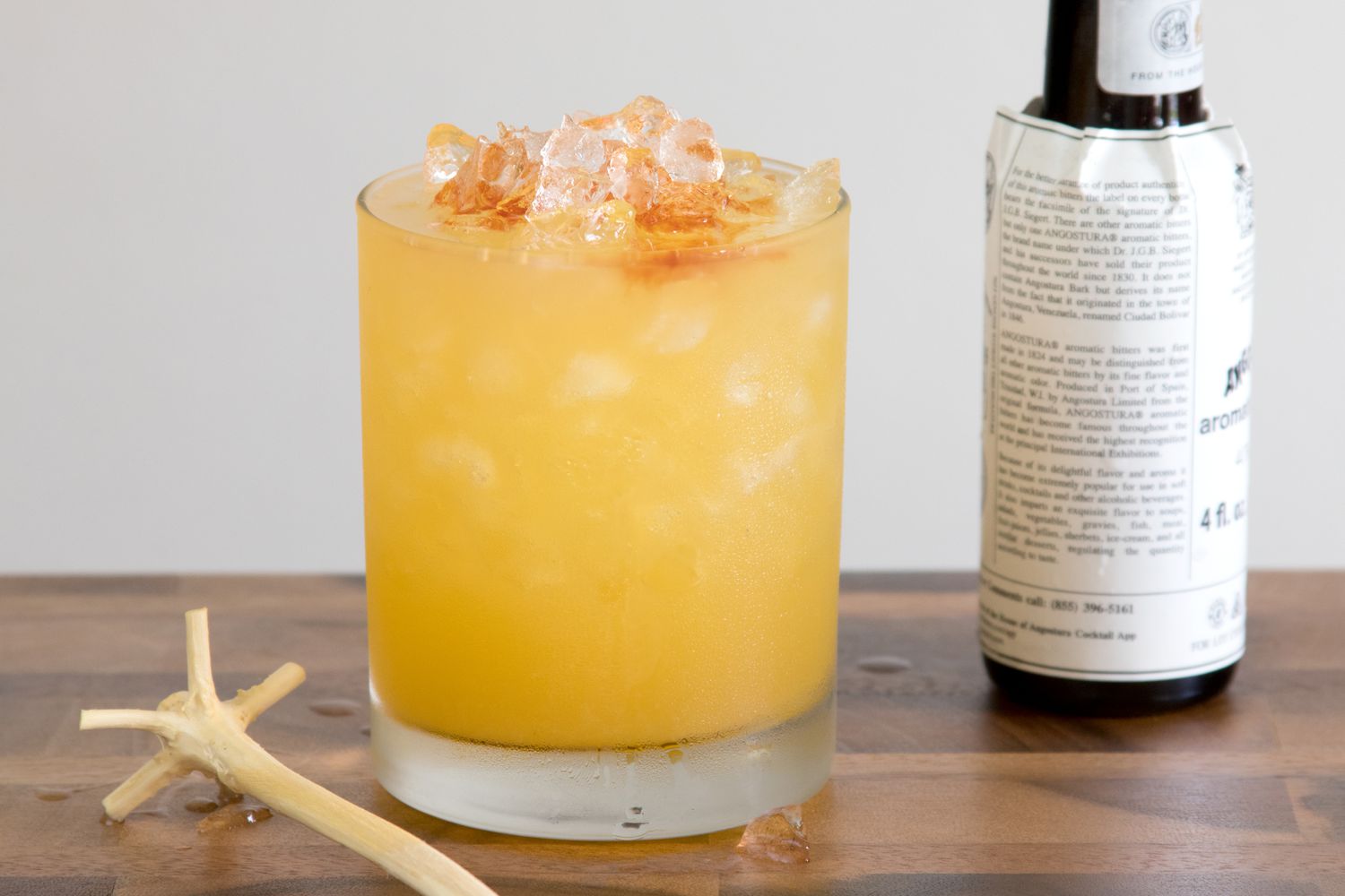 Adding Bitters to a Rum Swizzle Cocktail