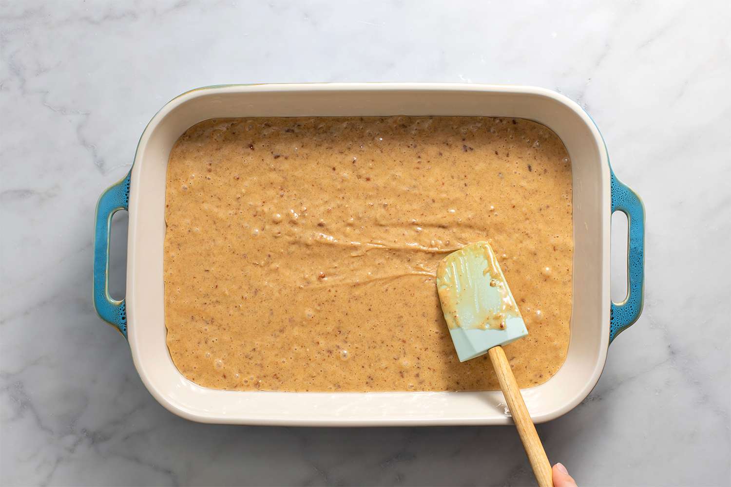 Cake in a baking dish, with a spatula 