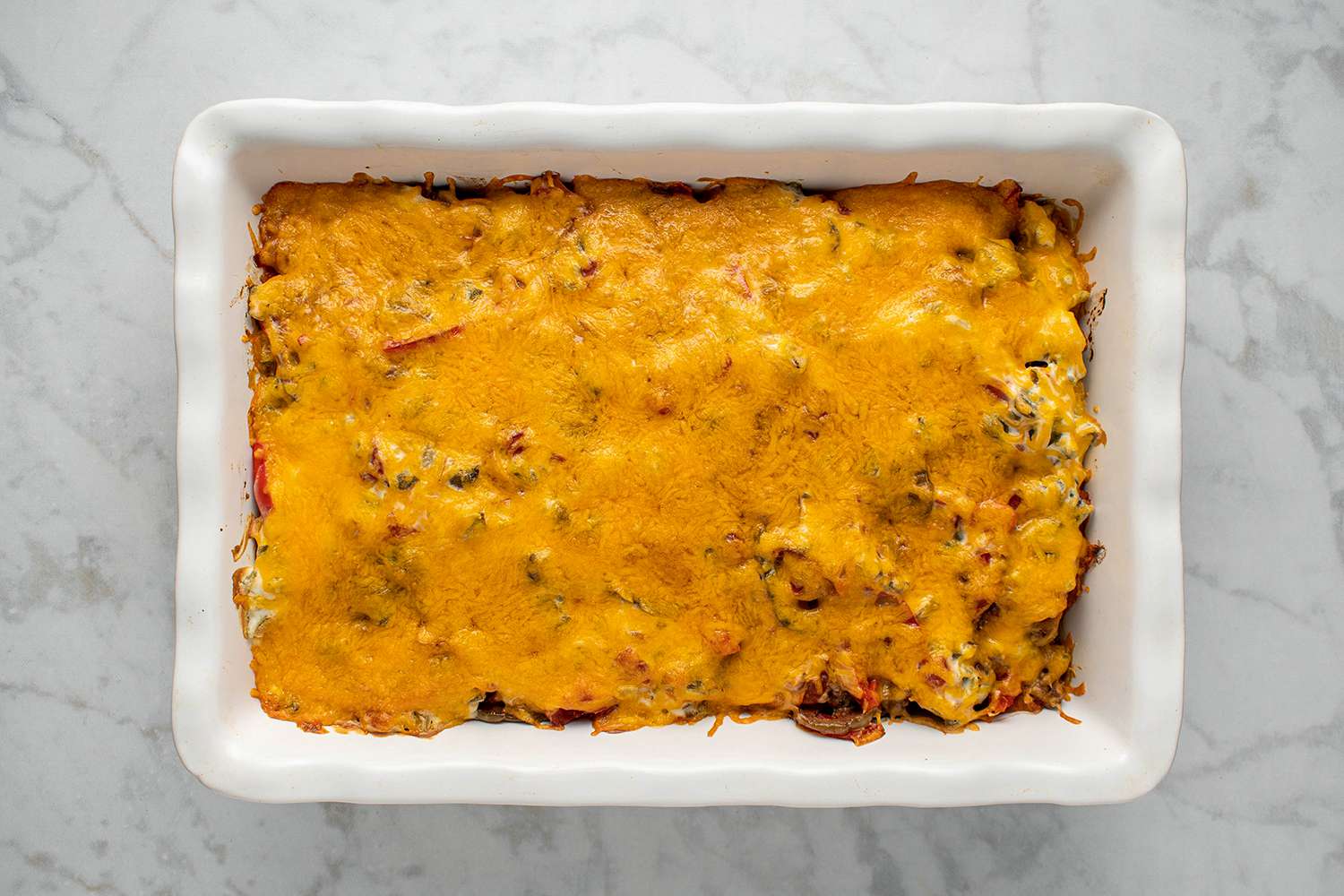 John Wayne casserole with melted cheese topping in a baking dish 