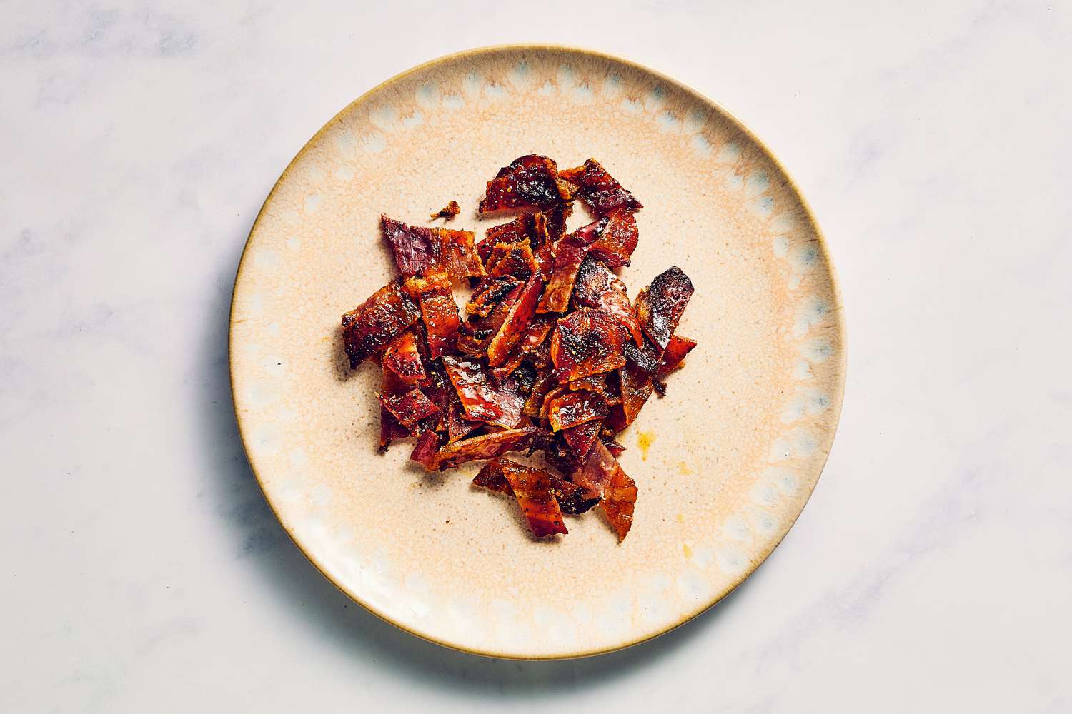 A plate with small pieces of million dollar bacon