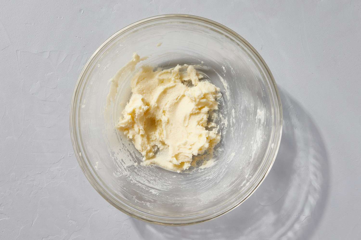A large mixing bowl with butter and sugar mixture