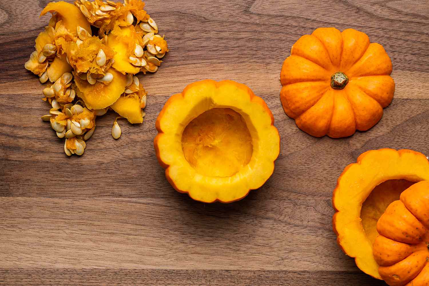 sliced open pumpkins with seeds scooped out