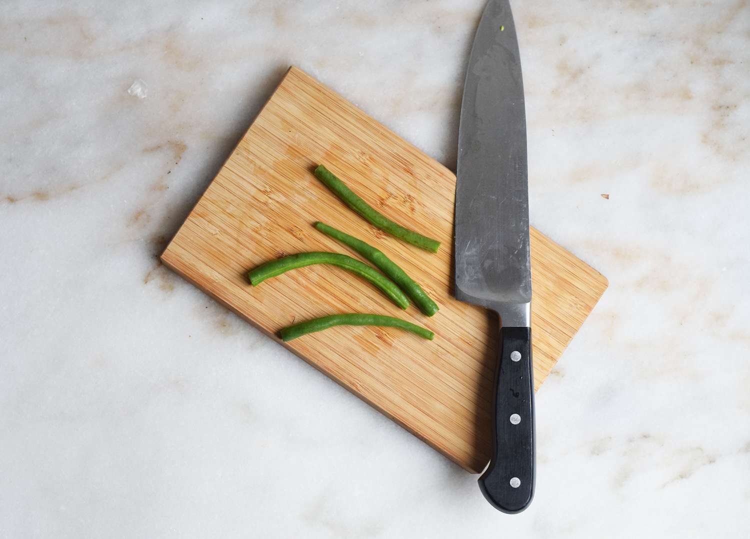 green beans trimmed on a cutting board