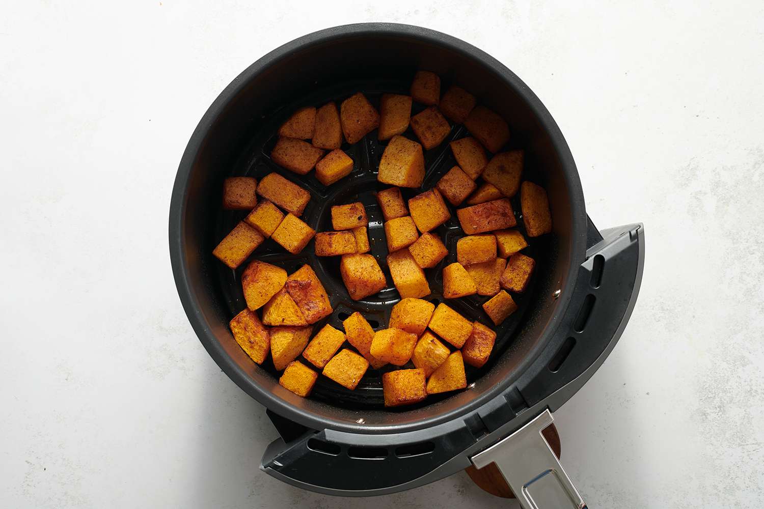 cubed butternut squash in an airfryer