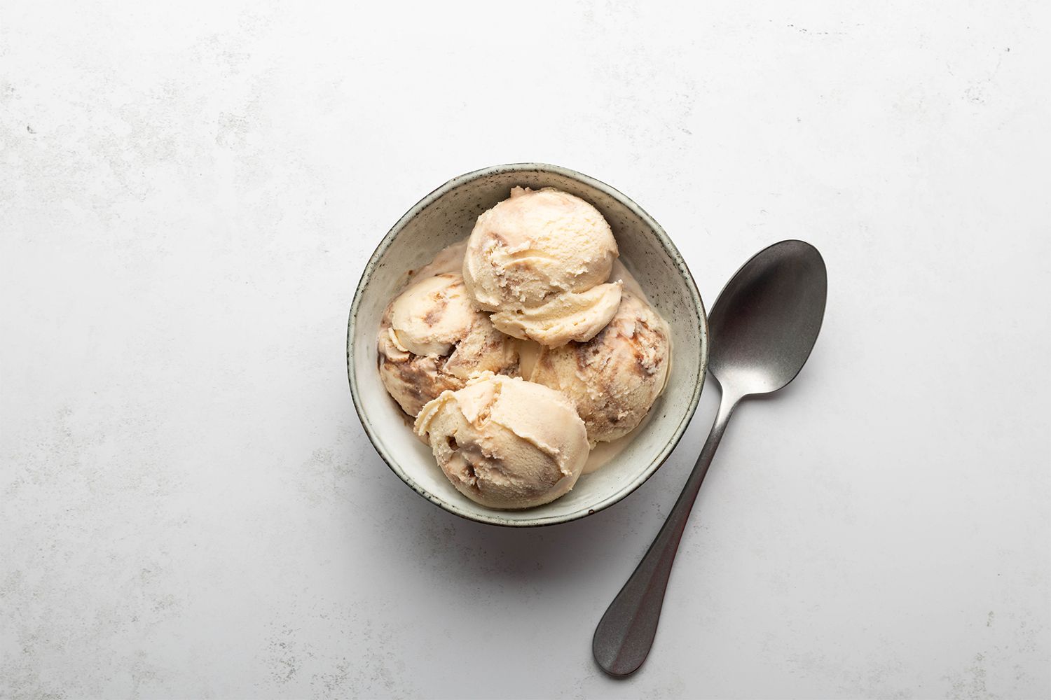 Peanut Butter Whiskey Ice Cream in a bowl with a spoon 