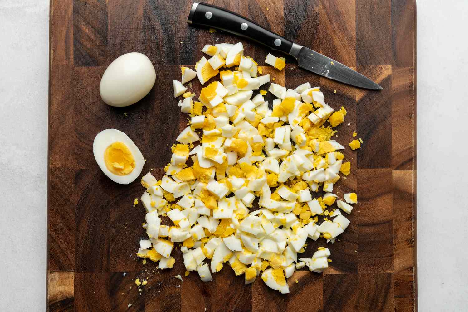 Coarsely chop the eggs on a cutting board 