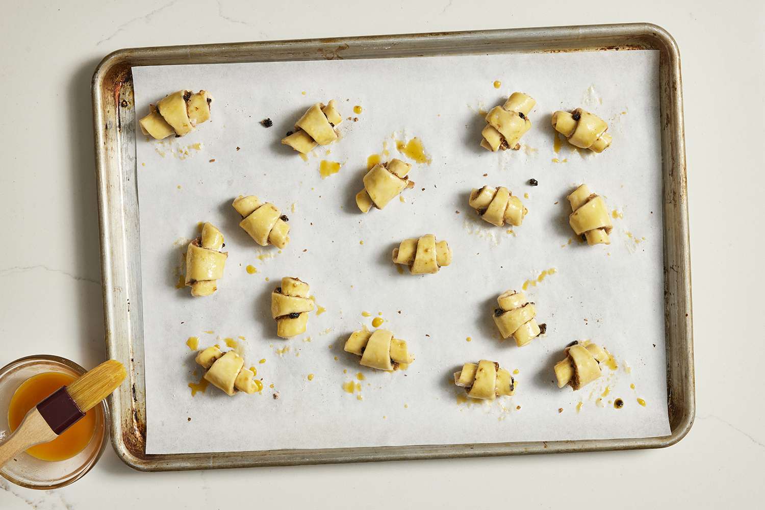 rugelach with egg wash on baking sheet