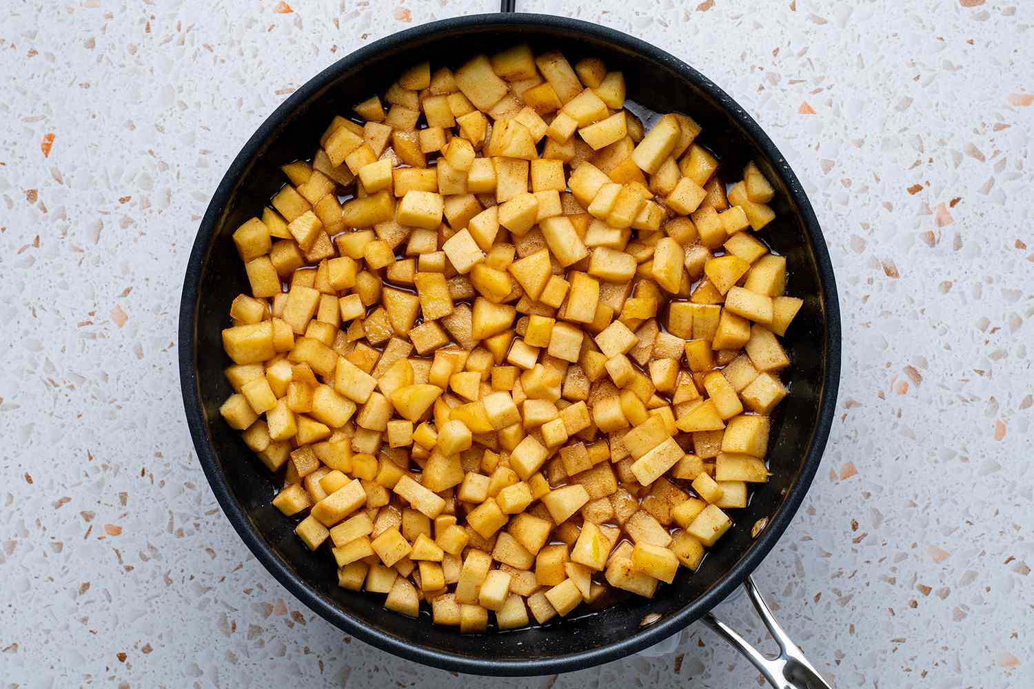 chopped apples cooking in a skillet