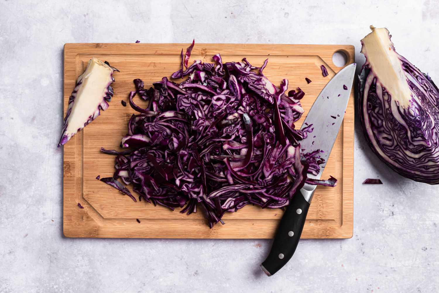 Thinly sliced red cabbage on a cutting board