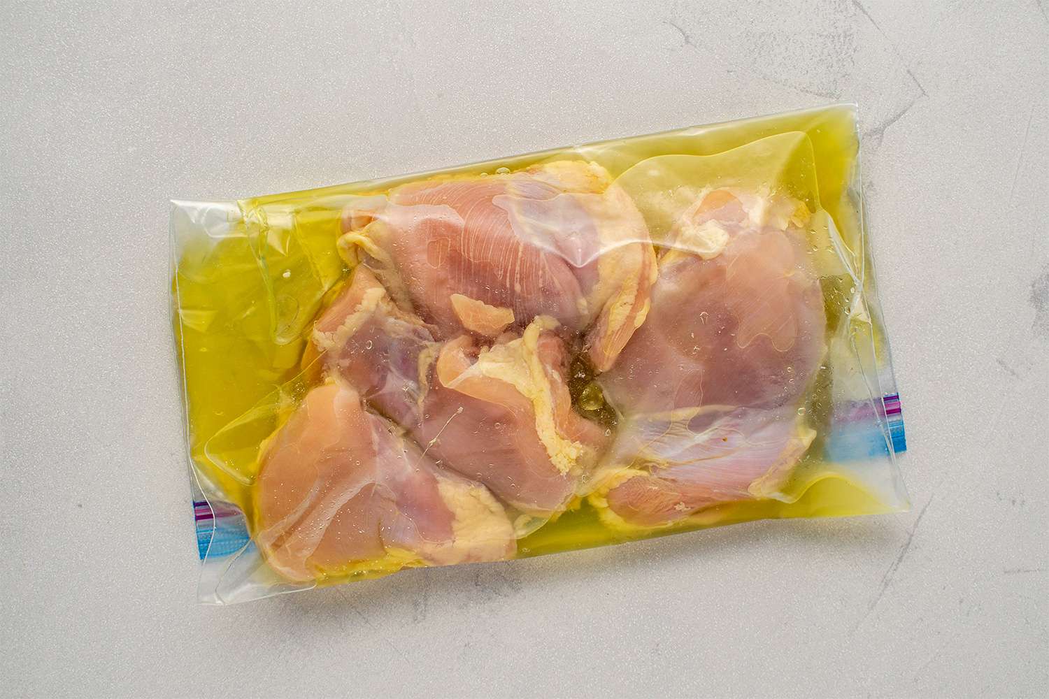 Chicken thighs and pickle juice in a zip-top bag
