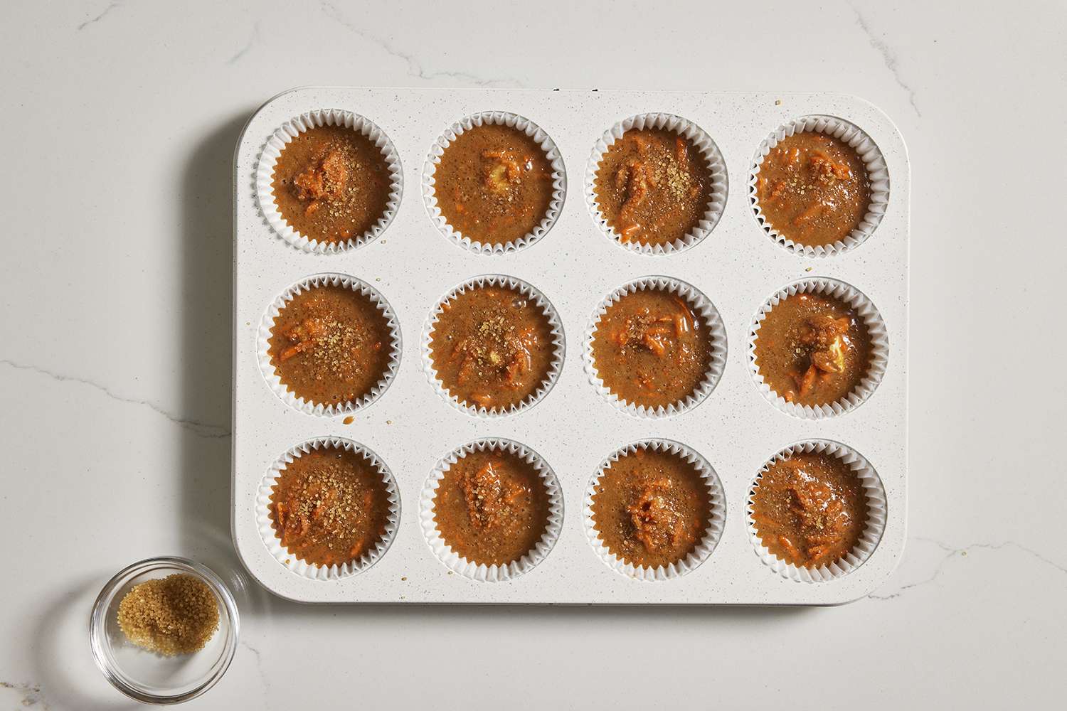 Muffin cups filled with more batter