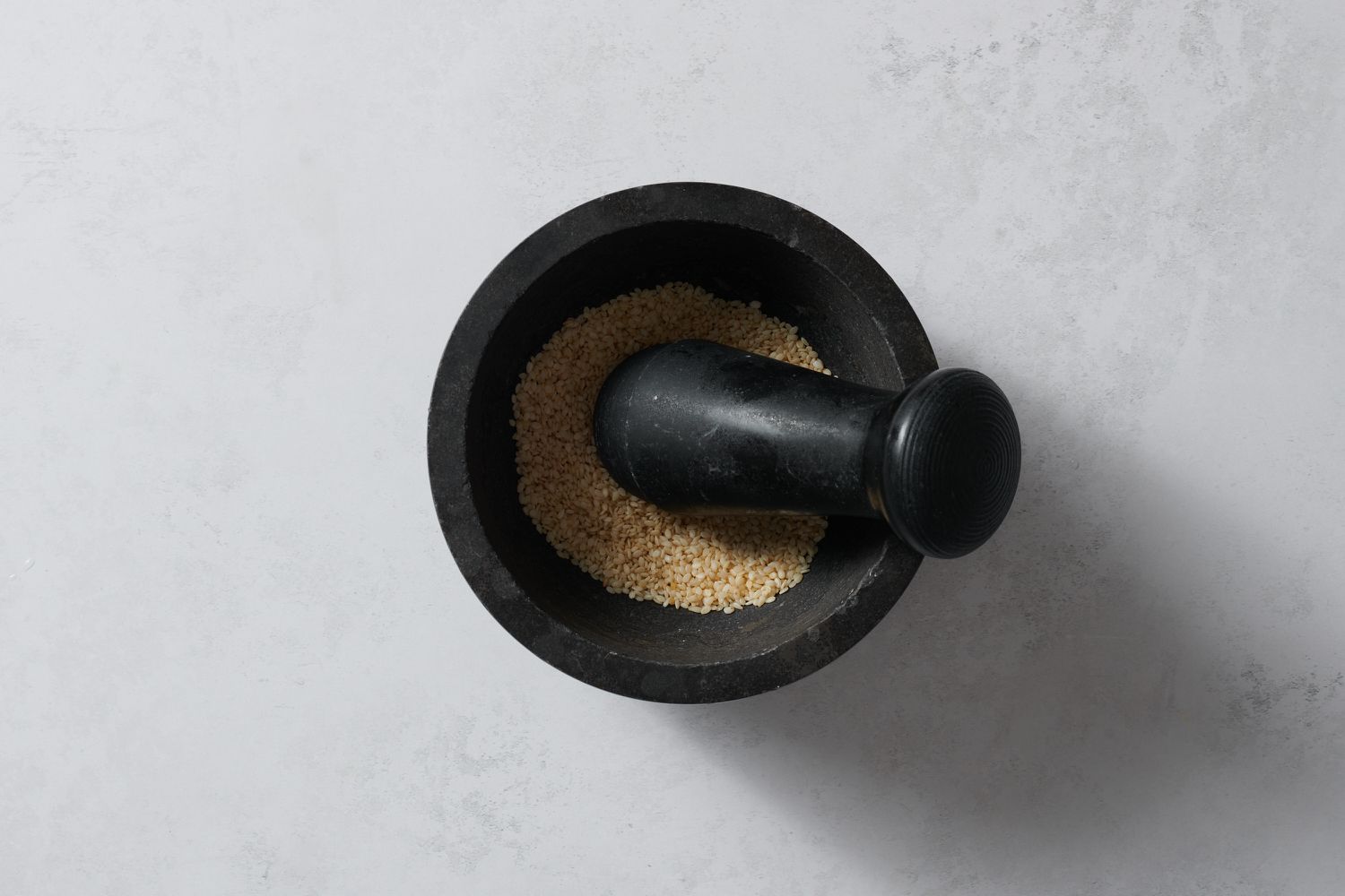 sesame seeds in a mortar and pestle