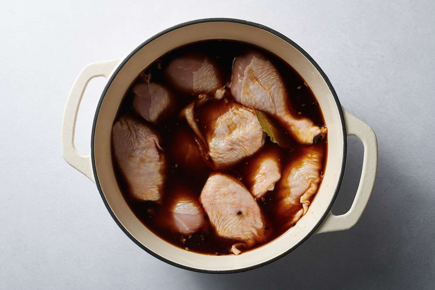 chicken marinating in a stock pot