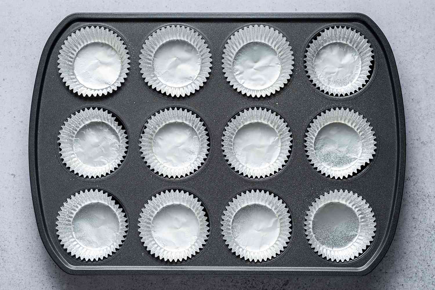 A muffin pan lined with liners