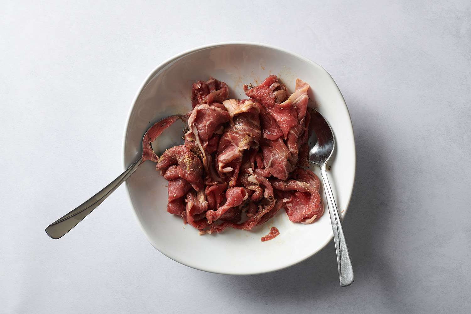 thinly sliced beef in bowl