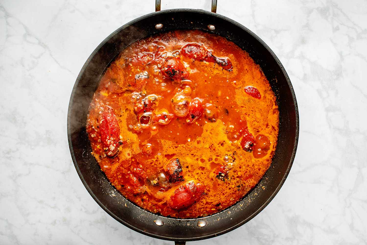 Arrabbiata Sauce ingredients cooking in a pan 