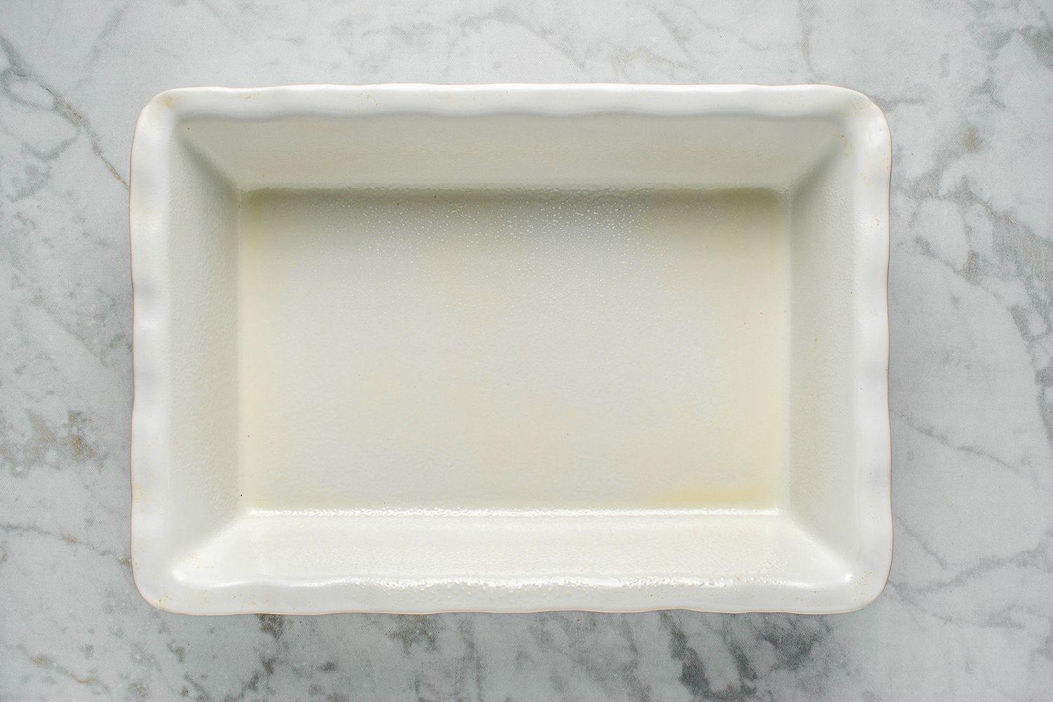 Well-greased white rectangular baking dish 