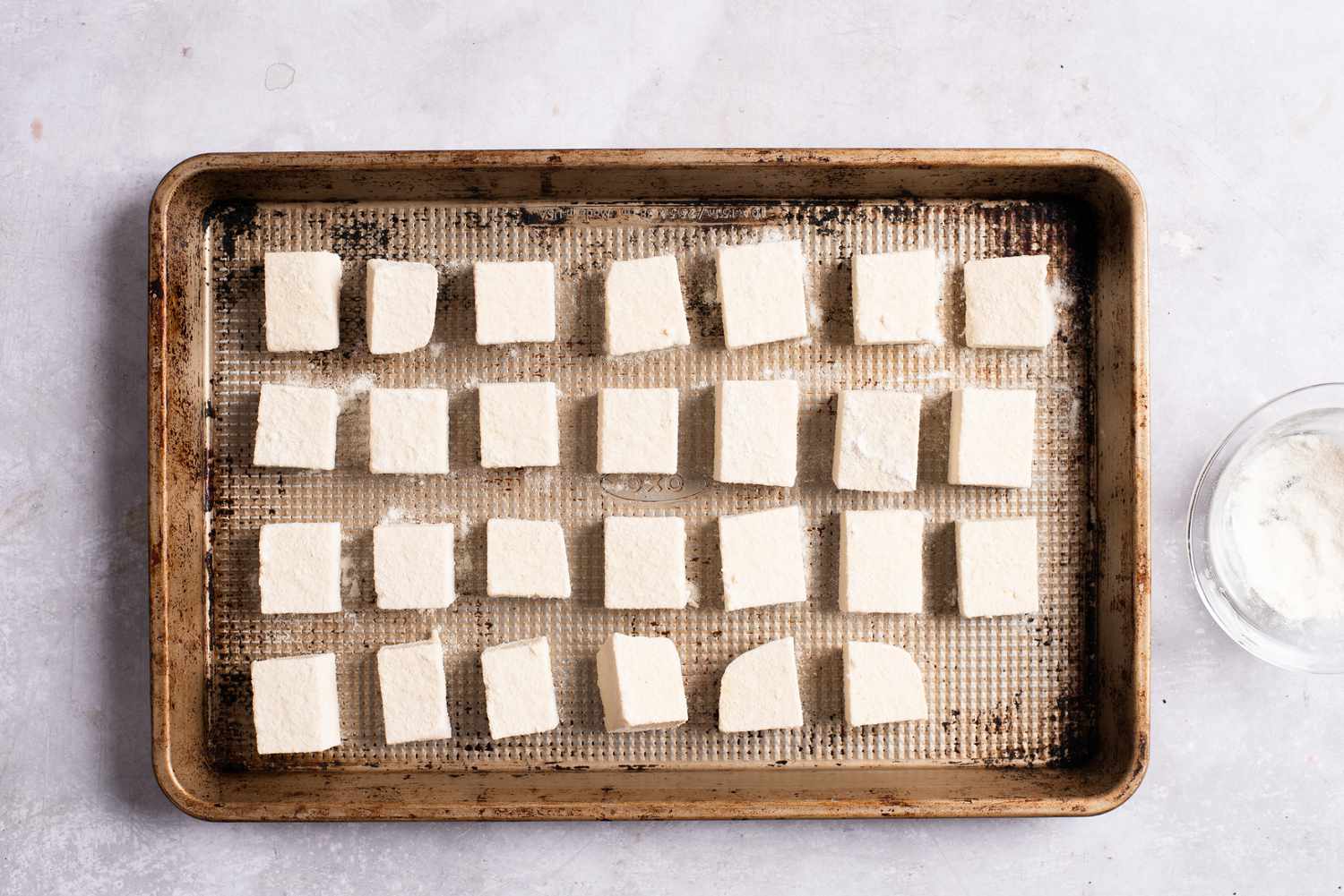 Rice flour-coated tofu on a baking sheet