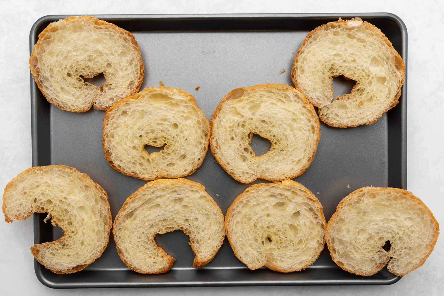 Sliced croissants on a baking sheet