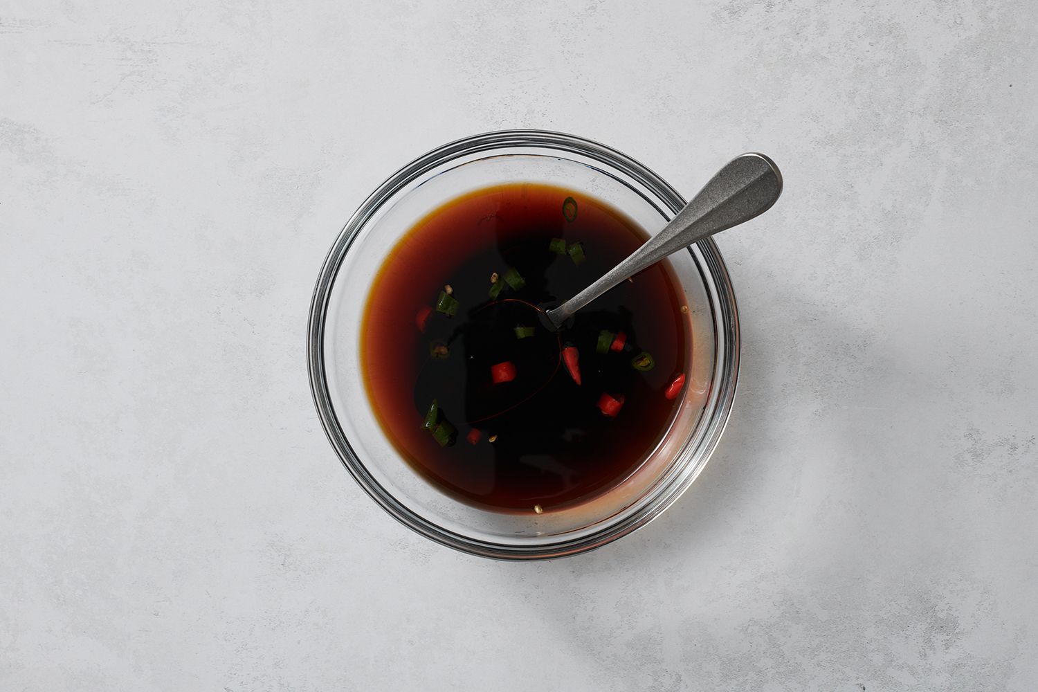 A small bowl of combined vinegar, soy sauce, and Thai chilies 