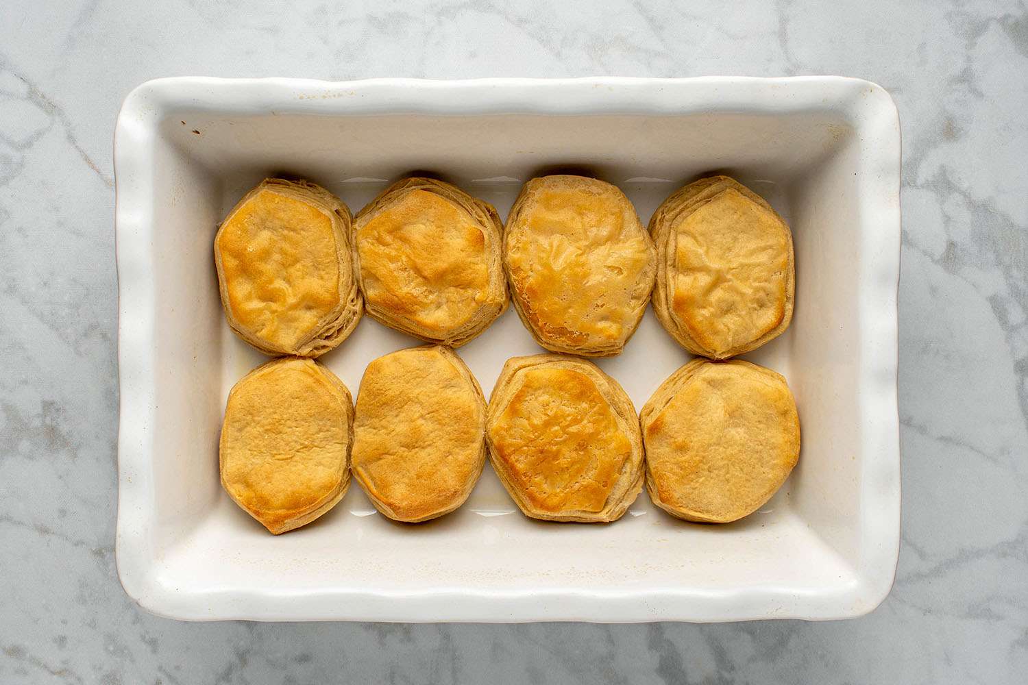 Golden-brown baked biscuits in the baking dish 