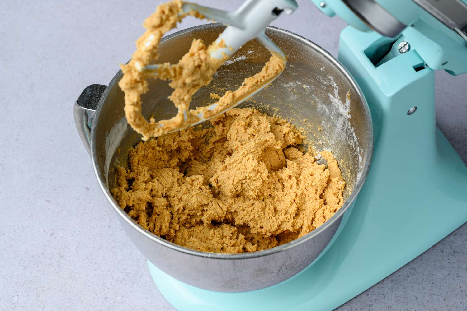 dry ingredients mixed into miso peanut butter cookie dough in bowl of stand mixer with paddle attachment