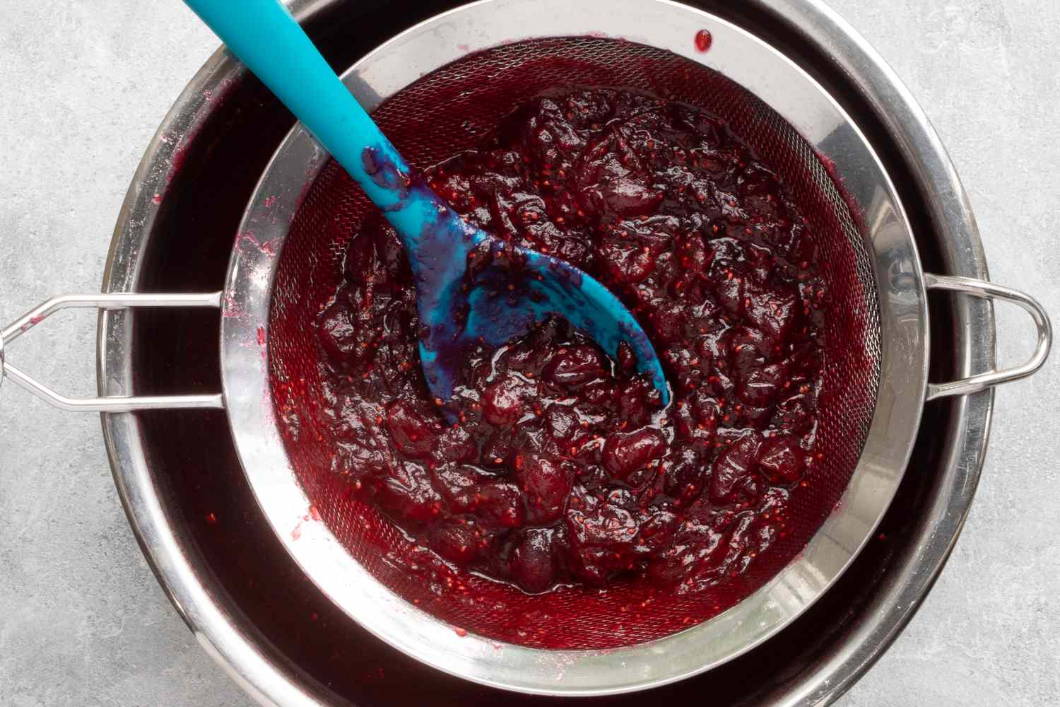 straining the cranberry sauce