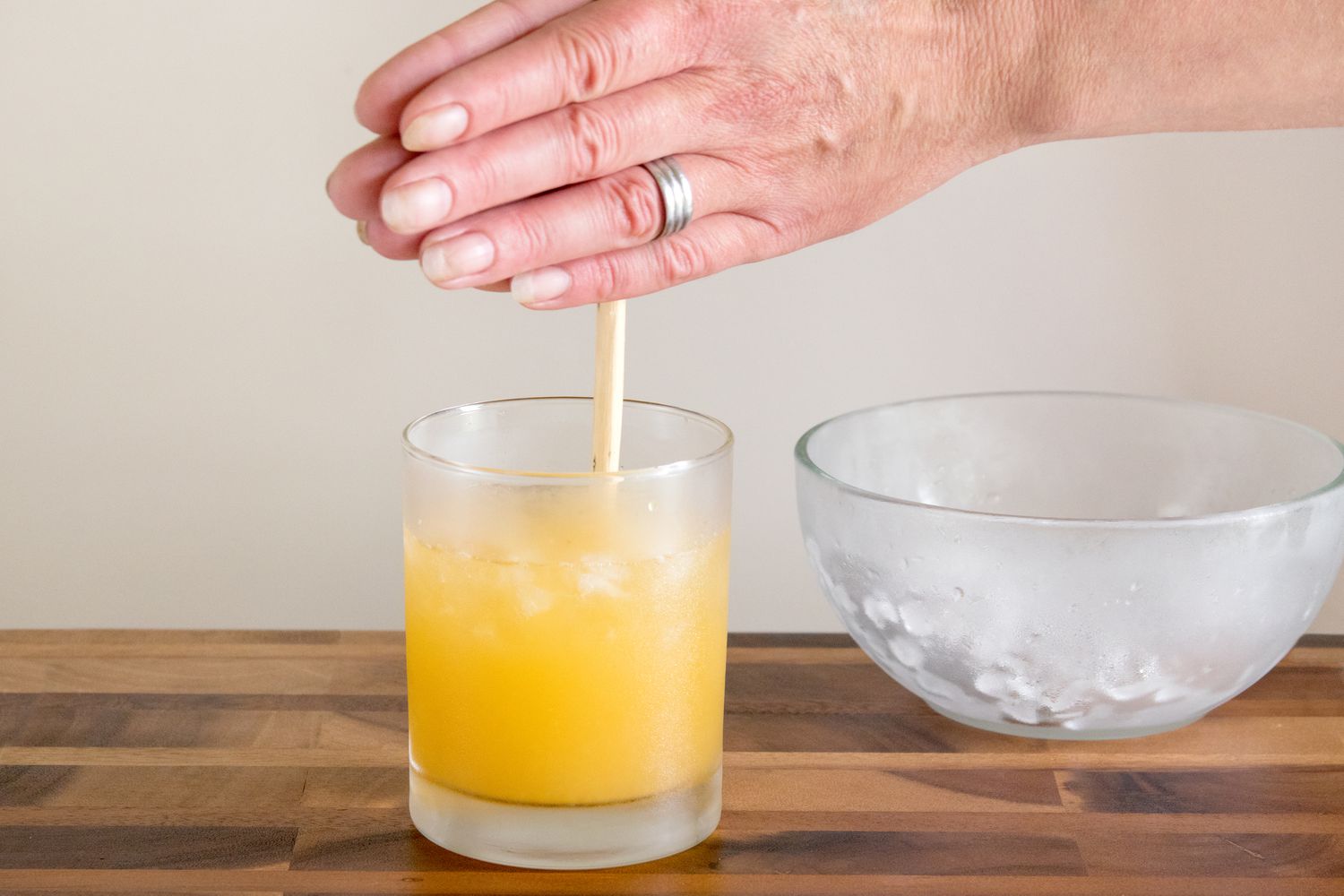 Mixing a Rum Swizzle Cocktail With a Swizzle Stick