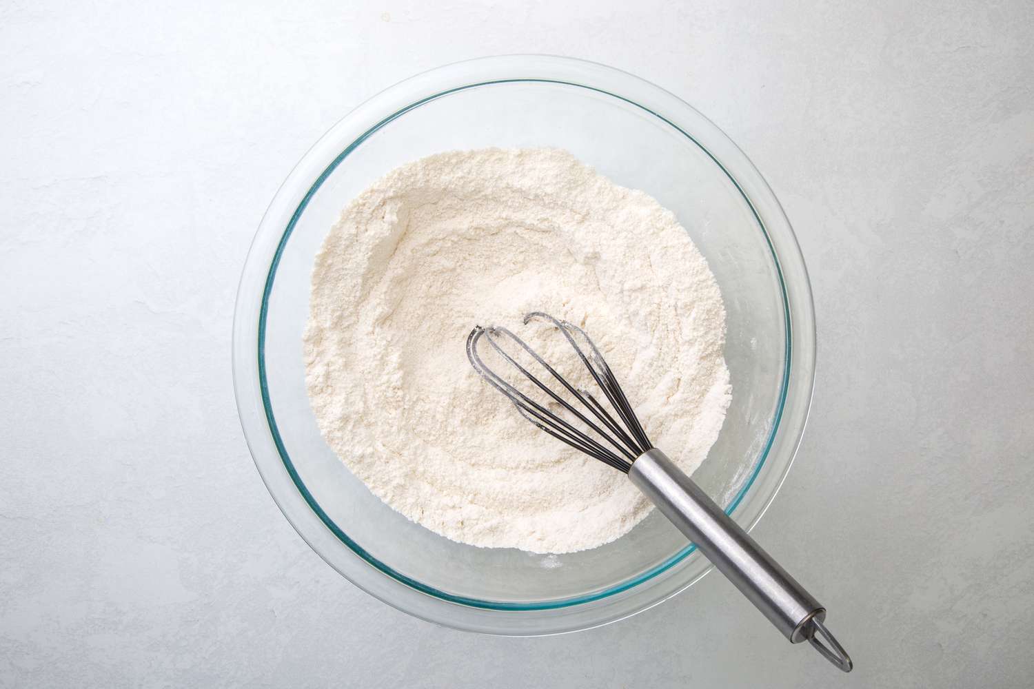 A bowl of flour, sugar, baking powder, and salt