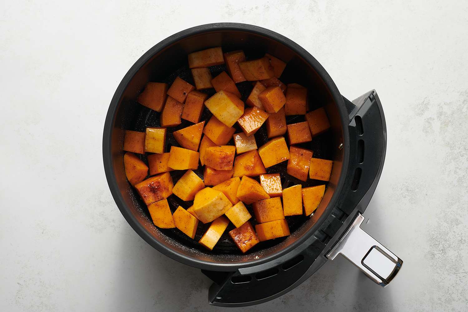 cubed butternut squash in an airfryer