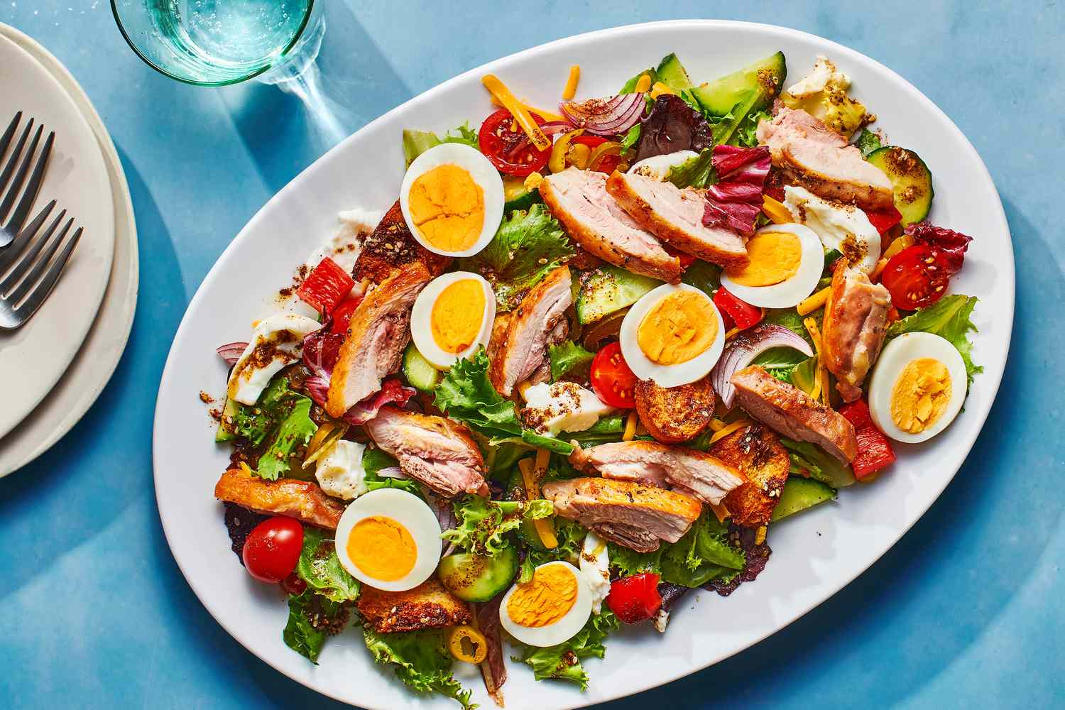 tiktok chicken salad on on plate with sliced chicken and hard boiled egg on top