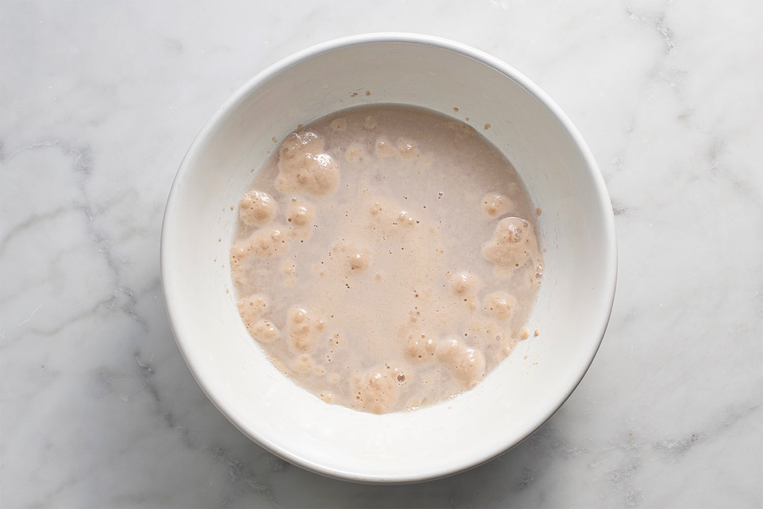 Yeast, sugar and water in a bowl 