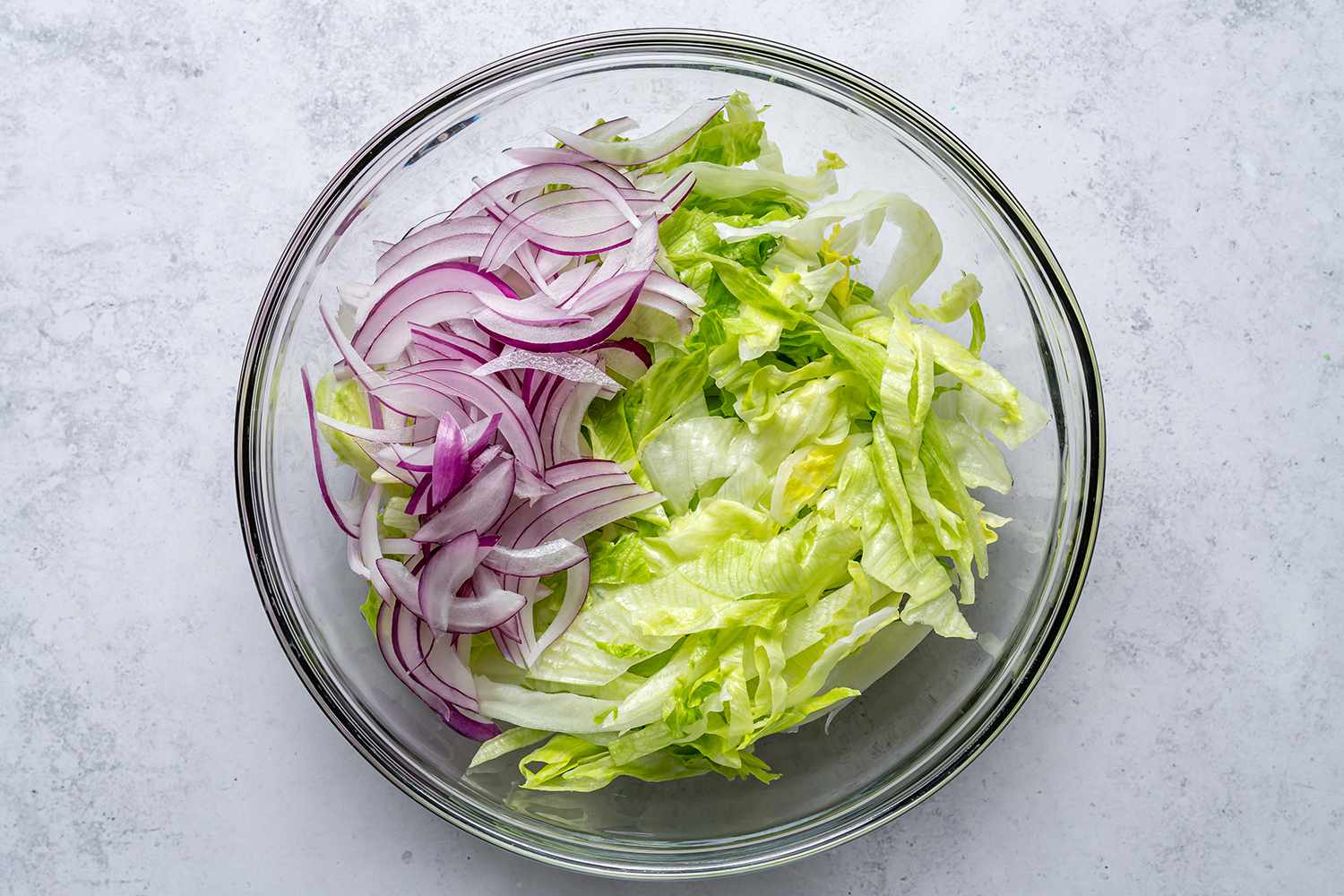 Sliced lettuce and onions in a bowl