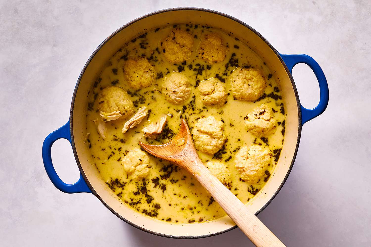 Keto Chicken and Dumplings in a pot, in a wooden spoon 