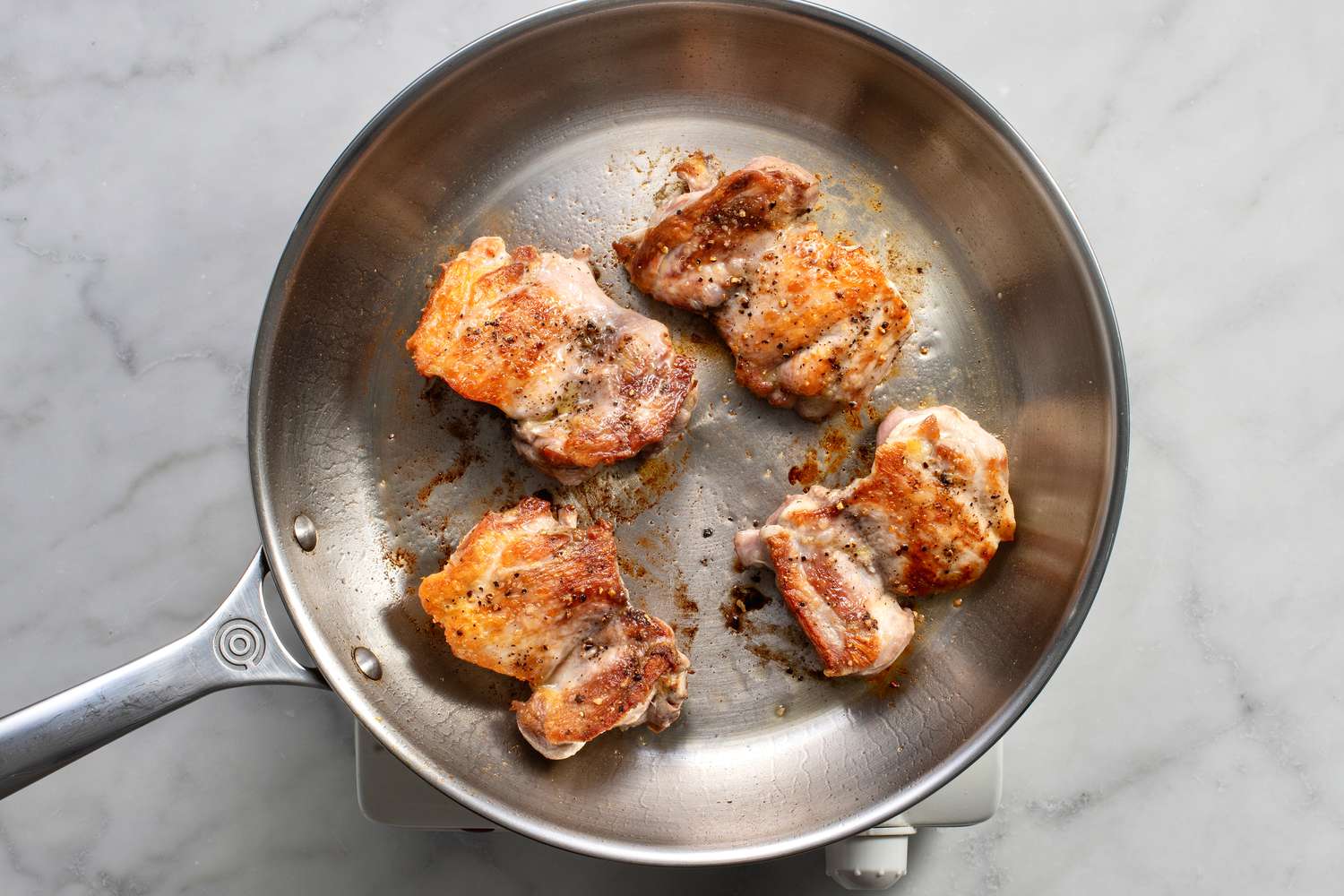 chicken being cooked in pan