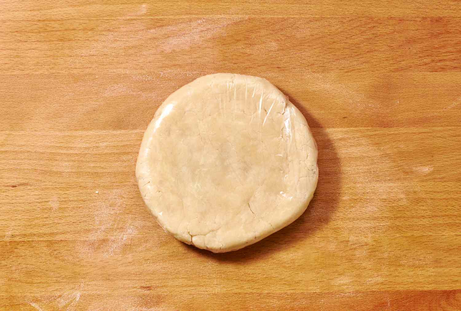 A small round disc of dough on a floured surface