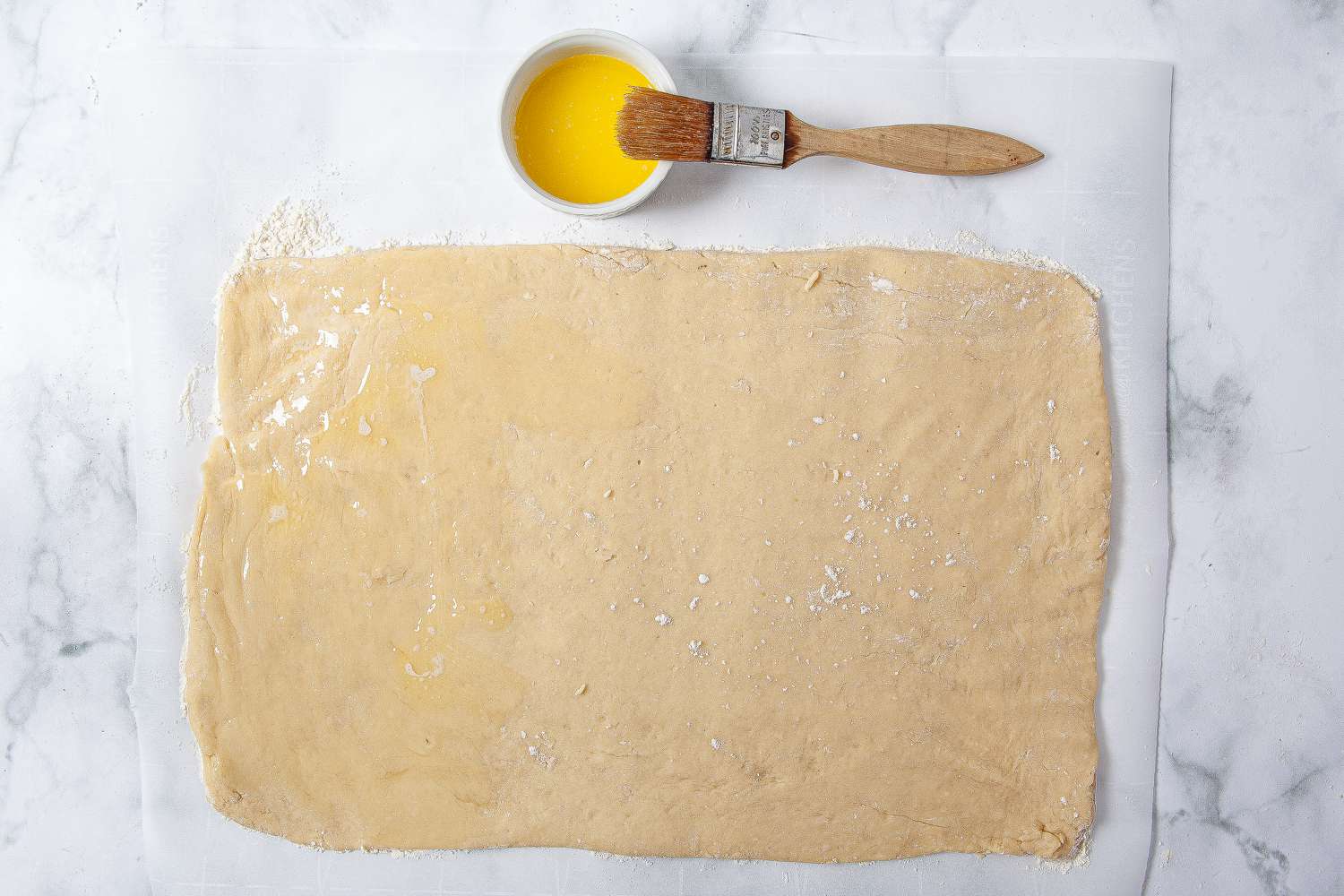 Brush the surface of the dough with melted butter