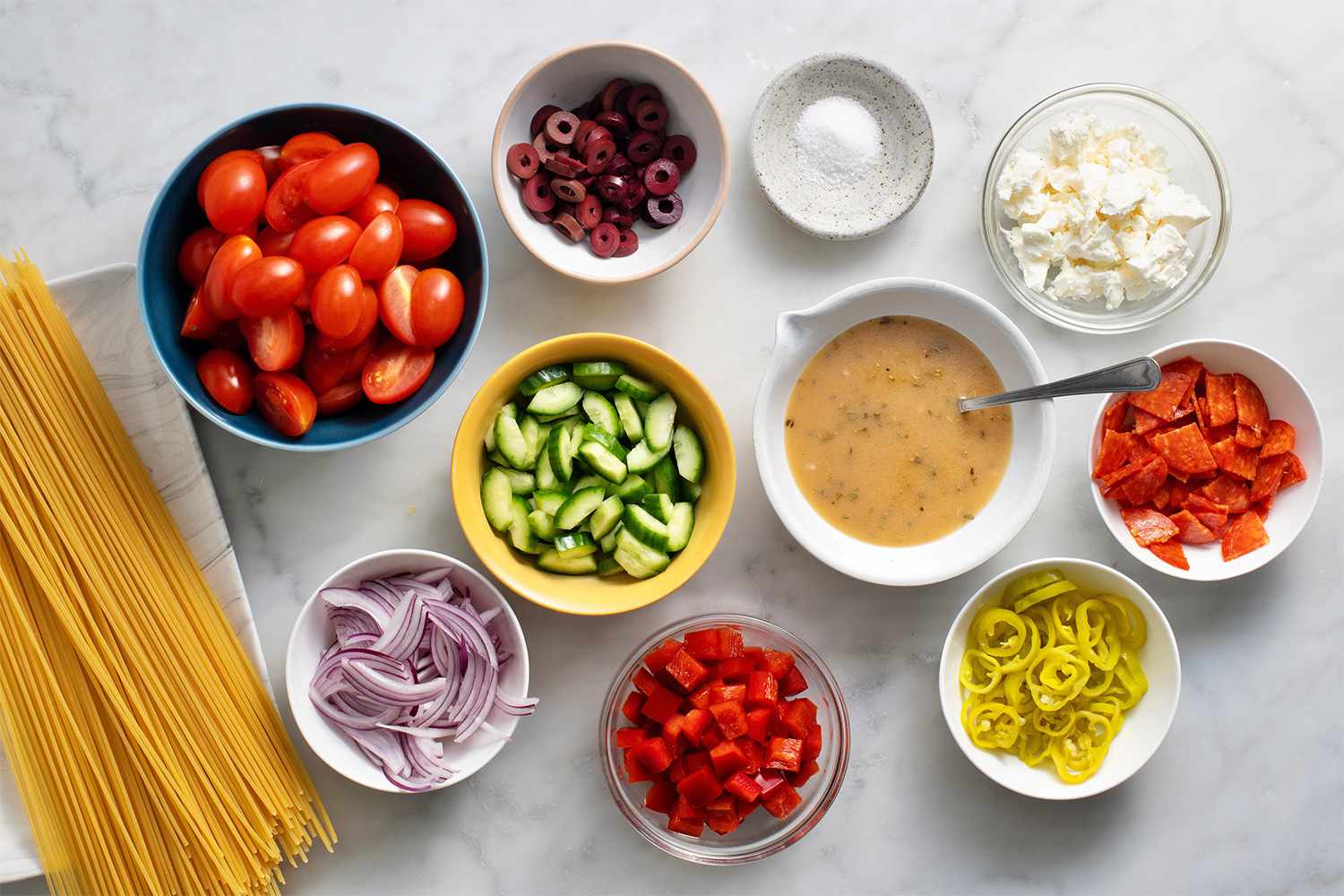 Spaghetti salad ingredients in bowls 