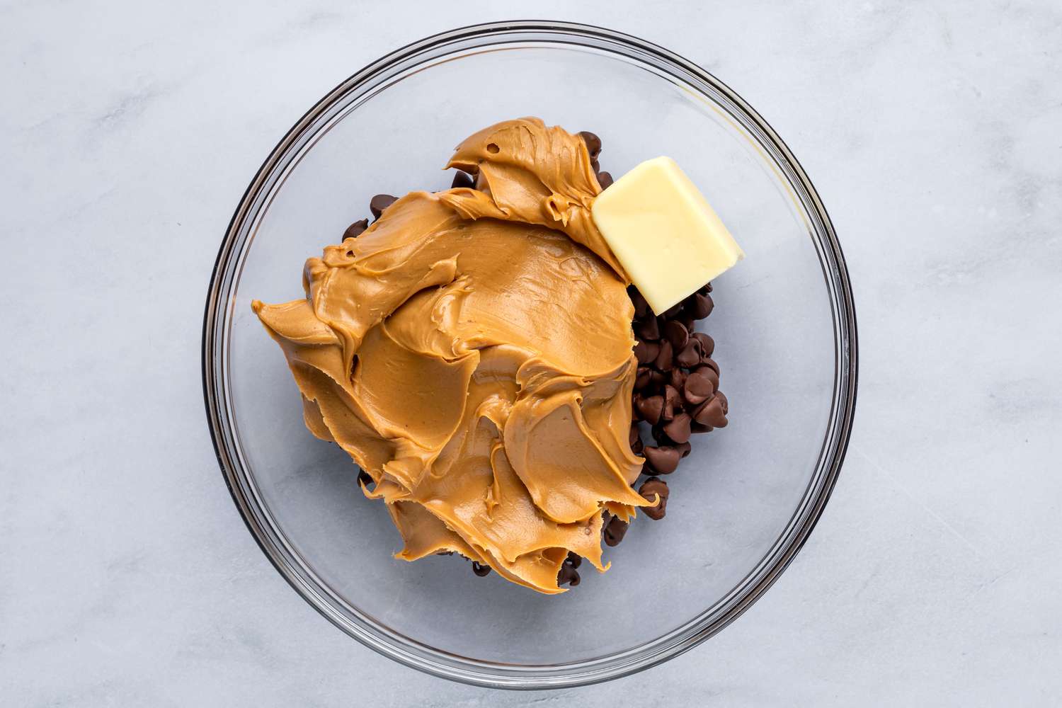 Chocolate, peanut butter, and butter in a large bowl