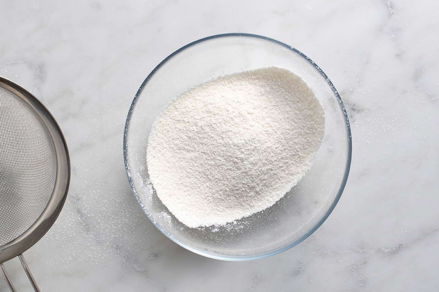 Sweetener, coconut flour, arrowroot flour, and salt sifted into a bowl