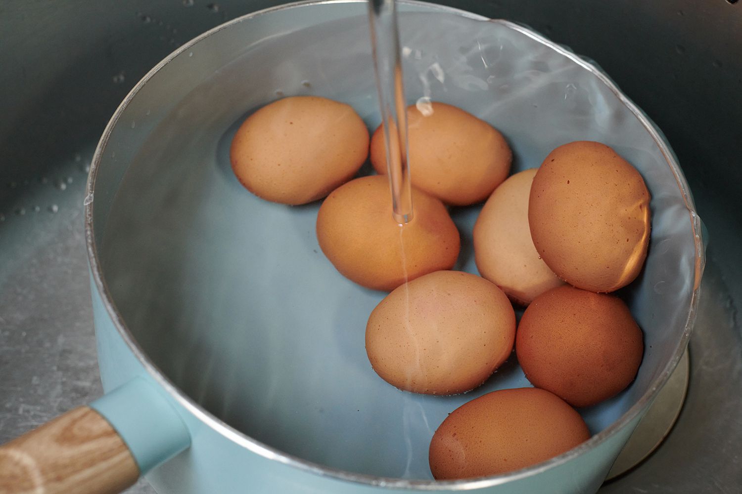A pot of eggs under running water