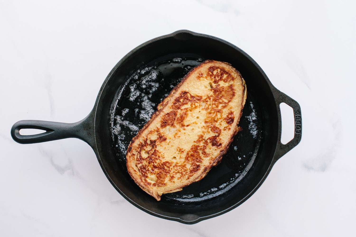Sourdough French toast cooking in a pan