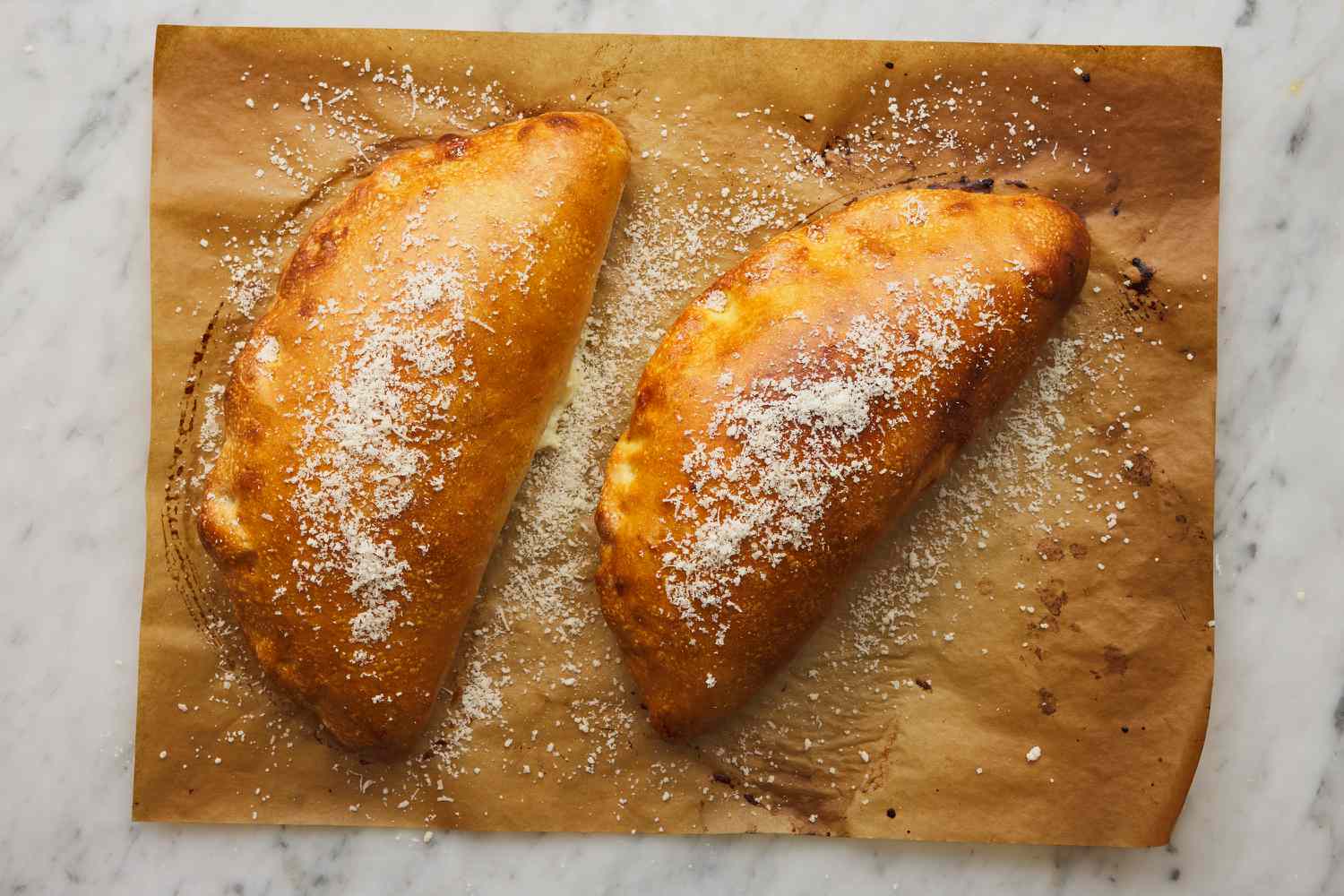 browned and baked calzones dusted with cheese
