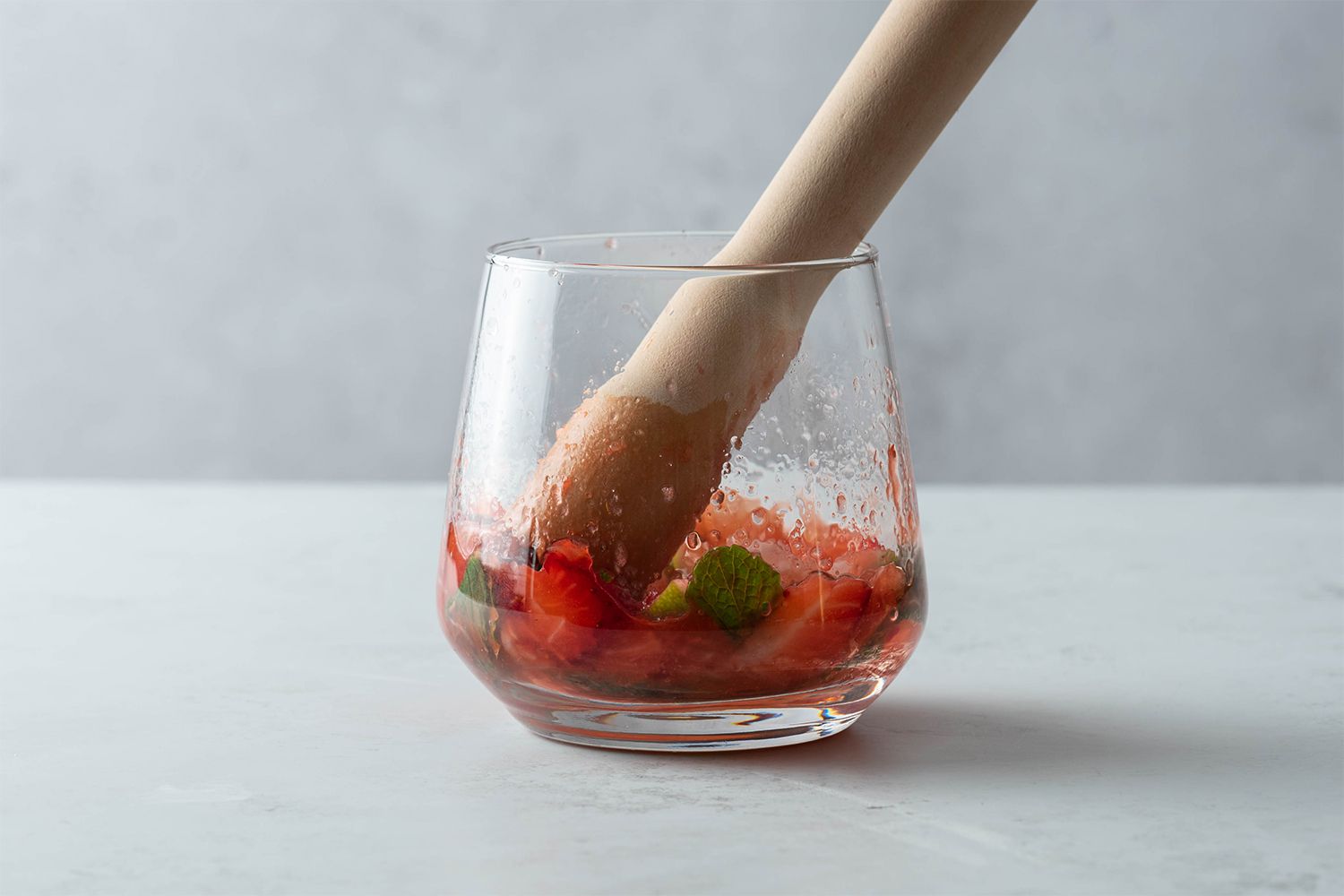 Muddle the fruit in a glass 